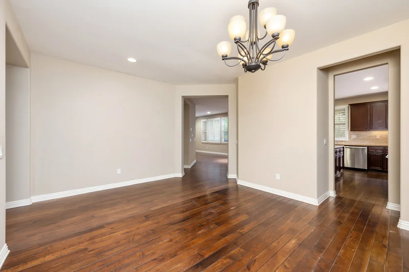 Professionally painted beige walls in dining room with hardwood floors. Professionally painted beige walls in dining room with hardwood floors.