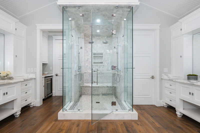 Luxury bathroom remodel with glass shower enclosure and white vanities. Luxury bathroom remodel with glass shower enclosure and white vanities.