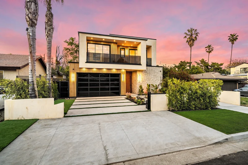 Professional exterior painting for a modern two-story home with warm lighting. Professional exterior painting for a modern two-story home with warm lighting.